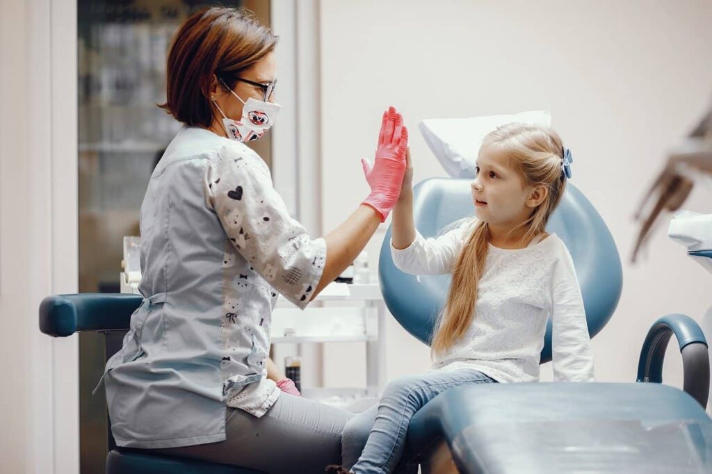 Child & dentist high five